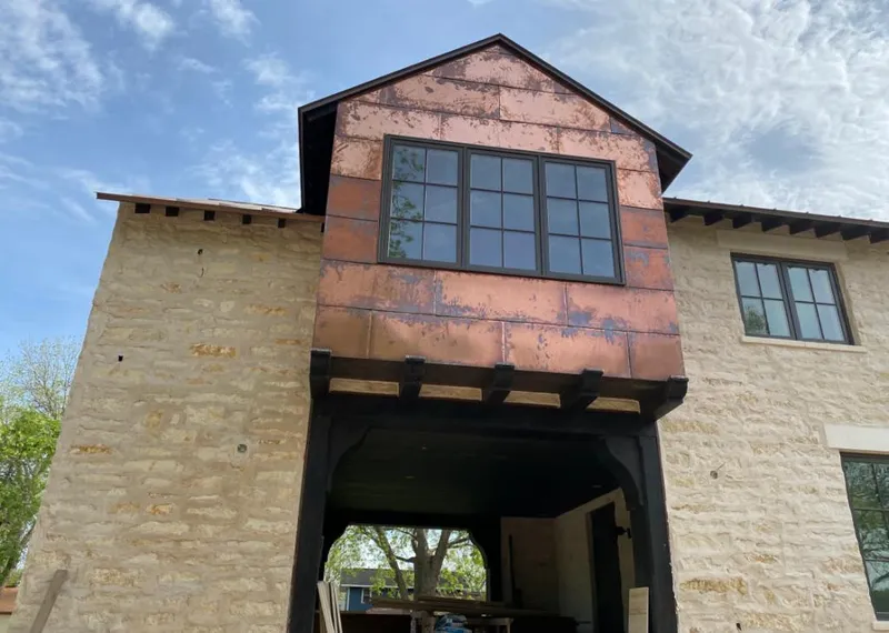 Copper metal panel facade on a stone building for Skylight Installation in Baldwin Park